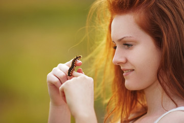 Girl holds brown caterpillar on her hand