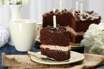 Delicious chocolate cake on table on light background