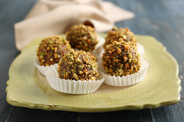 Tasty homemade pistachio candies on wooden table