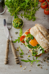 Ciabatta with fried egg, tomatoes and pesto