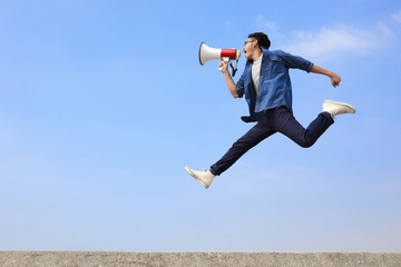 man jump and shout megaphone