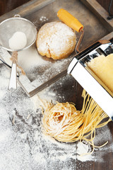 Making vermicelli with pasta machine and sprinkled flour