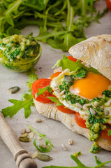 Ciabatta with fried egg, tomatoes and pesto