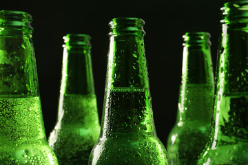 Glass bottles of beer on dark background