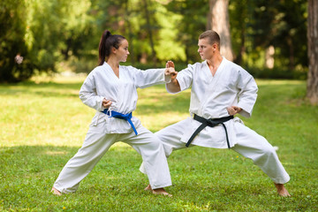 Two martial arts fighters practicing in nature