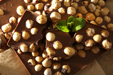 Chocolate with nuts on parchment, closeup