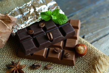 Delicious chocolate with spices on wooden table, closeup