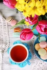 Fototapeta na wymiar Composition of spring flowers, tea and cookies on table