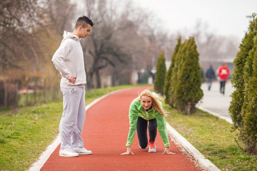 Fototapeta premium Young female athlete practicing with her coach