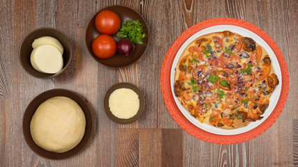 Pizza and the ingredients for cooking