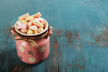 Sweet candies on color wooden background