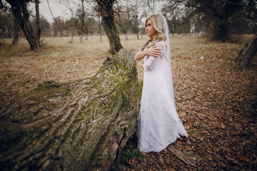 bride walking in golden autumn nature