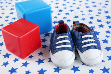 Baby shoes on cloth background