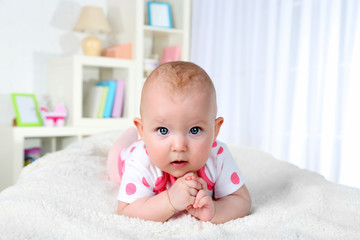 Cute baby girl, on home interior background