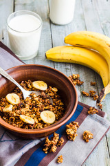 homemade granola with bananas, nuts and dates, milk