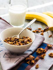 banana granola with nuts, figs and honey in a white piala