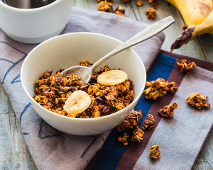 banana granola with nuts, figs and honey in a white piala