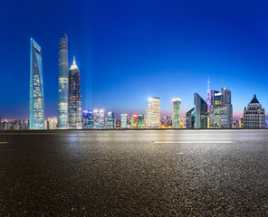 urban road,illuminated skyline background