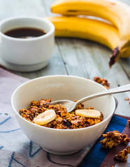 banana granola with nuts, figs and honey in a white piala