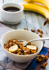 banana granola with nuts, figs and honey in a white piala