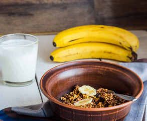 banana granola with nuts, figs and honey in a white piala