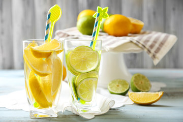 Cocktails with fresh citrus fruits on wooden background