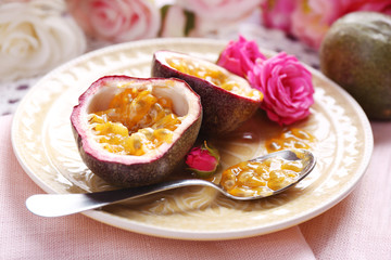 Passion fruit on plate on color wooden background