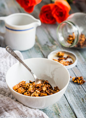 homemade granola with nuts and dried fruit, honey, flowers