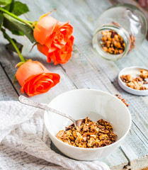 homemade granola with nuts and dried fruit, honey, flowers