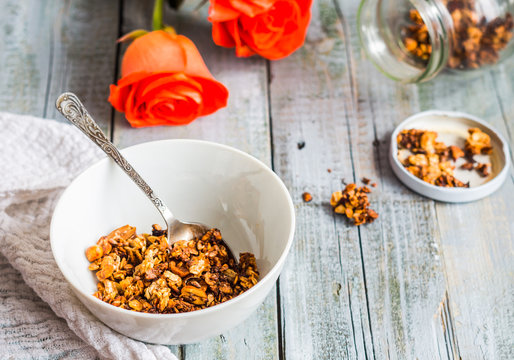 homemade granola with nuts and dried fruit, honey, flowers