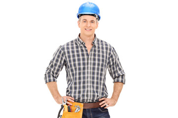 Confident construction guy in uniform wearing helmet and posing