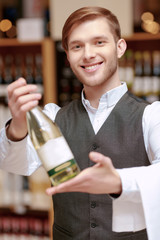 Sommelier in the store near shelves