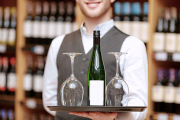 Sommelier with a tray and glasses