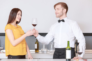 Sommelier pours wine into glass