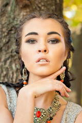 Young beautiful woman face with necklace