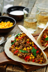 tacos with meat, corn and peppers