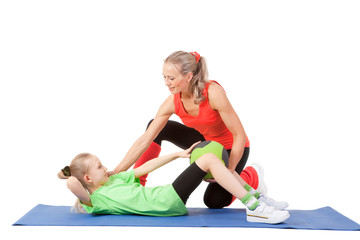 Little girl doing exercise with an instructor