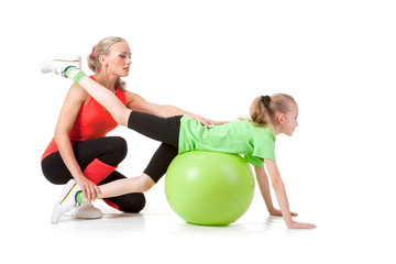 Little girl doing exercise with an instructor