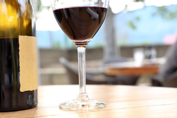 Composition with wineglass and bottle of red wine