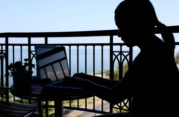 Silhouette of businesswoman using computer