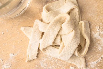Fototapeta na wymiar Strips of dough cooked pasta