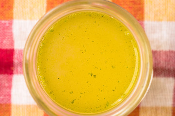Homemade broth in the pot top view
