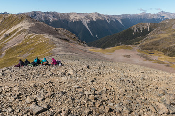 tourists resting on mountain range in Nelson Lakes National Park