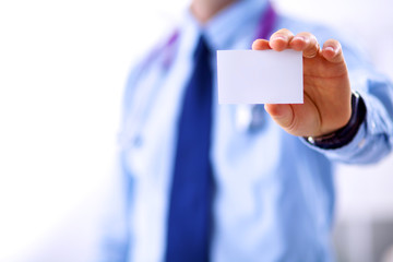 Male doctor holding empty white card