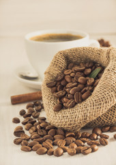 coffee beans and cup on wood