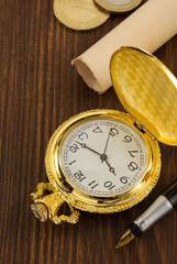 old pocket watch on wood