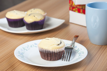 a chocolate cupcake with cream cheese on top