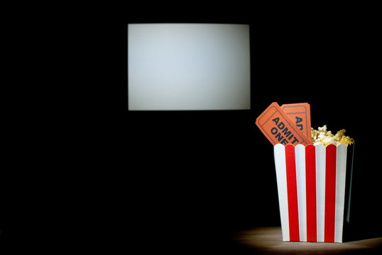 popcorn with tickets on a white background screen