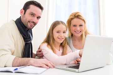 Happy family in front of a laptop