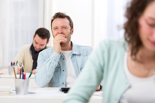 Young attractive student yawn during classes